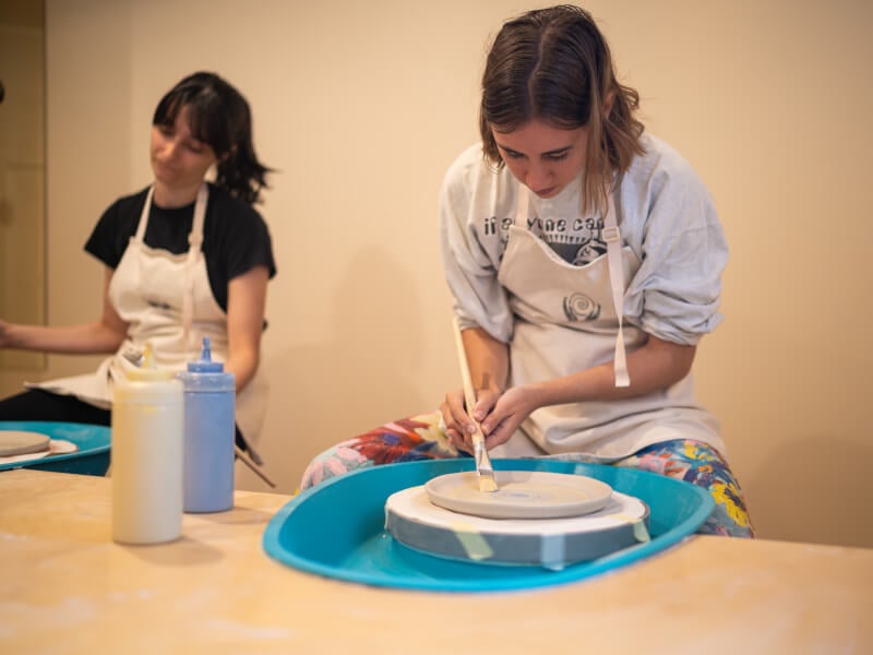 Woman painting ceramics